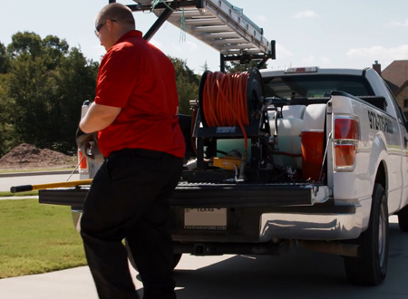 Pest Force technician and truck with ladder