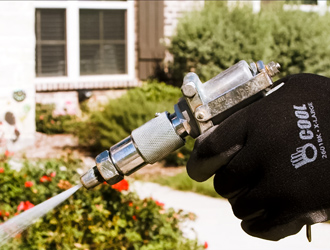 Up close of technician's hand spraying yard