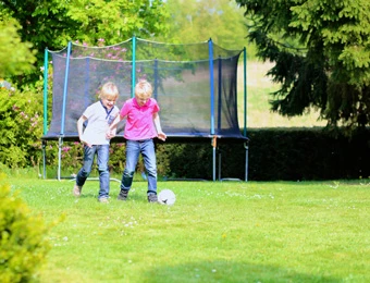 Children playing on a grassy lawn