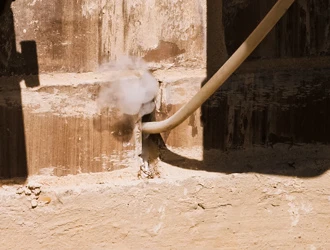 Pest control treatment injected into concrete foundation