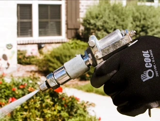 Close-up of pest control sprayer used outside a home